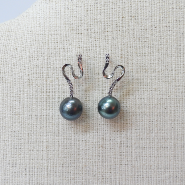 Elegant black pearl earrings with sterling silver hooks and diamond accents.