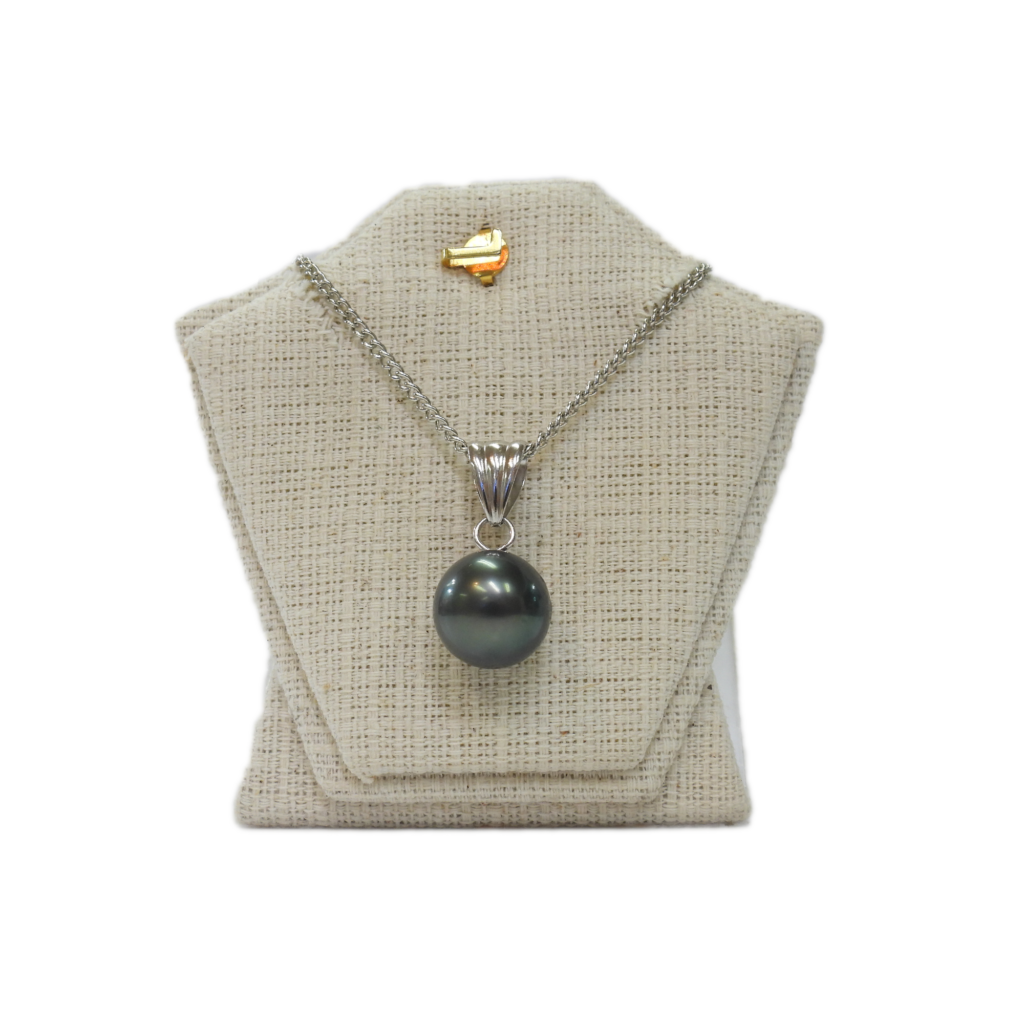 Shimmering black pearl pendant necklace on silver chain displayed on jewelry bust.